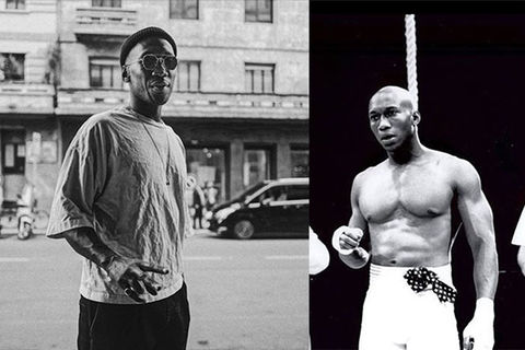 Mahershala-Ali. Black and white photos of Black man wearing black hat , gray Tee and black pants next to younger photo of same Black man with bald head wearing white boxing shorts.