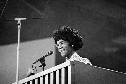 Shirley Chisholm. Black and white photo of Black woman with short curly hair at podium.