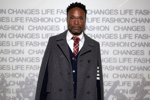 Billy Porter. Black man with short dark hair wearing glasses, tie, white shirt and wool poncho.