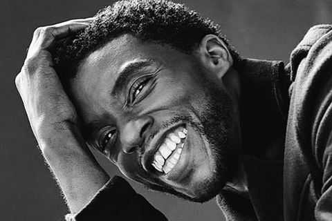 Chadwick Boseman. Black and white photo of Black man with short dark hair smiling.