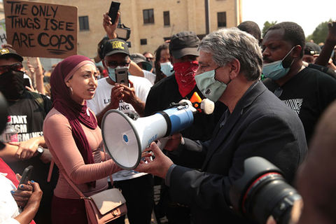 Jacob Blake protest. Crowd stands around a white man with gray hair holding a bullhorn.