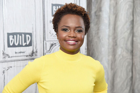 Karine-Jean-Pierre. Black woman with short brown hair wearing a yellow top.