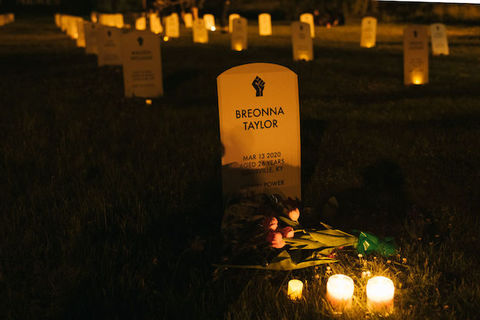 A marker surrounded by candles says Breonna Taylor