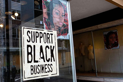 Black Business. Sotrefront with a picture of Breonna Taylor on the window and a sign reading Support Black Business.