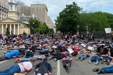 Protesters lie face down on a street near the White House. 