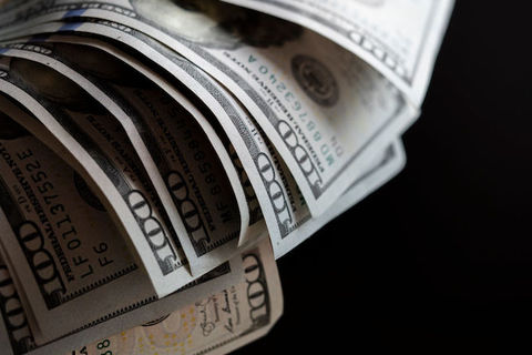 Close-up image of U.S. $100 bills. 