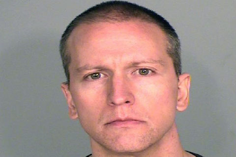 close-up image of white man with somber expression. 