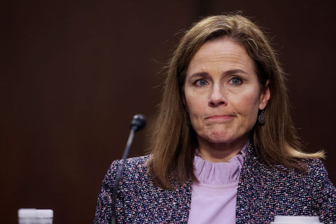 Close-up of older white woman with brown hair and a perplexed look on her face. 