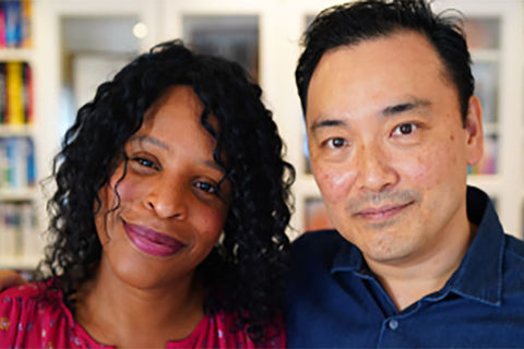 Yoons. Black woman with dark shoulder length hair and red shirt next to Asian man with dark hair in blue shirt.