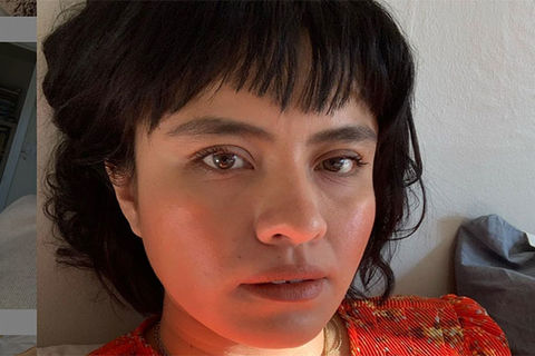 Karla Cornejo Villavicencio. Latinx woman with short dark hair wearing a red top.