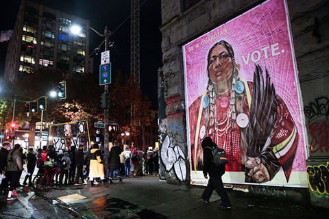 Native-American-Vote. Artwork on side of a building of Native American woman dressed in traditional attire.