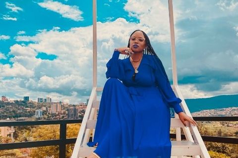 Actress and expatriates, Tiara Phalon, in a blue dress, posing in Kigali, Rwanda