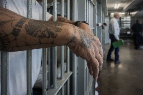 A prisoner's hands inside a punishment cell wing at Angola prison. The Louisiana State Penitentiary, also known as Angola, is nicknamed the "Alcatraz of the South" and "The Farm".