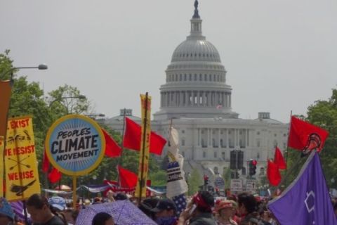 People marching outside the Capitol Building during a People's Climate March