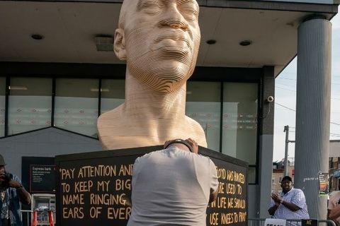Terrance Floyd weeps during the unveiling of a statute dedicated to his brother George Floyd at Flatbush Junction on June 19, 2021
