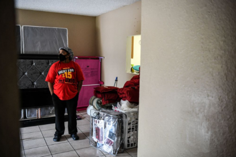 Deatrice Edie, a McDonald's employee, looks on at her home after a protest outside a branch restaurant for a raise in their minimum wage to $15 an hour