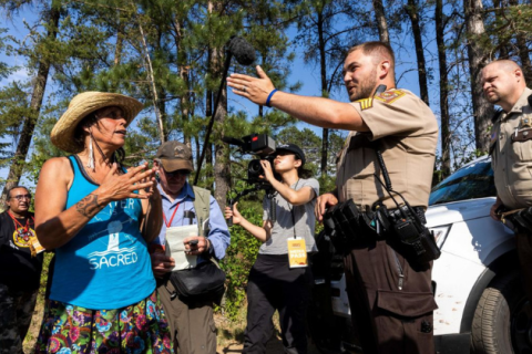 Indigenous environmental and land rights activist Winona LaDuke talks to Hubbard County Sheriff near the stock pile of Enbridge Pipeline 3 in Park Rapids, Minnesota