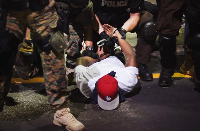 Another Night in Ferguson: Arrests, Pepper Spray and Gun Aimed Right to the Chest
