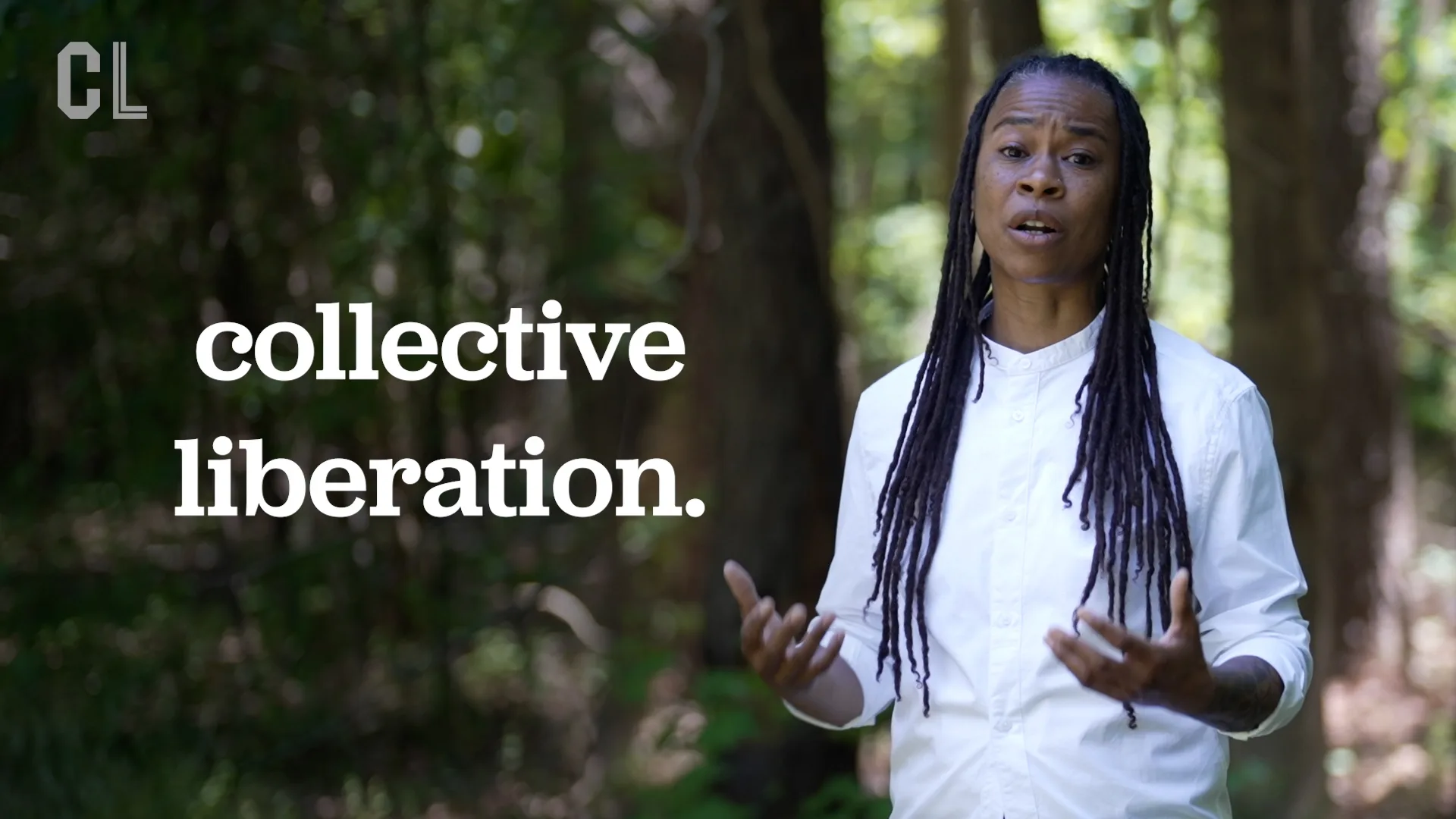 Erica Woodland stands in a forested setting and explains what healing justice is and how it's connected to collective liberation.
