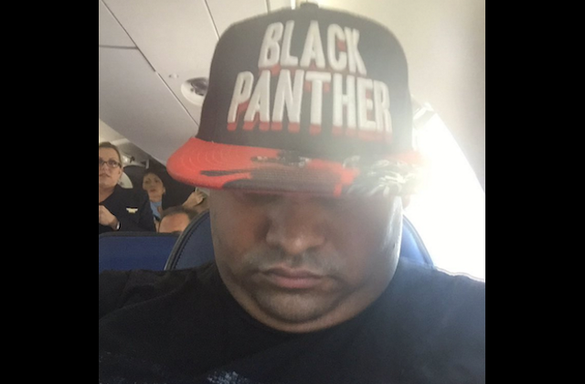 Journalist Kicked Off Flight for Wearing ‘Black Panther’ Hat, Upside-Down Flag Tee
